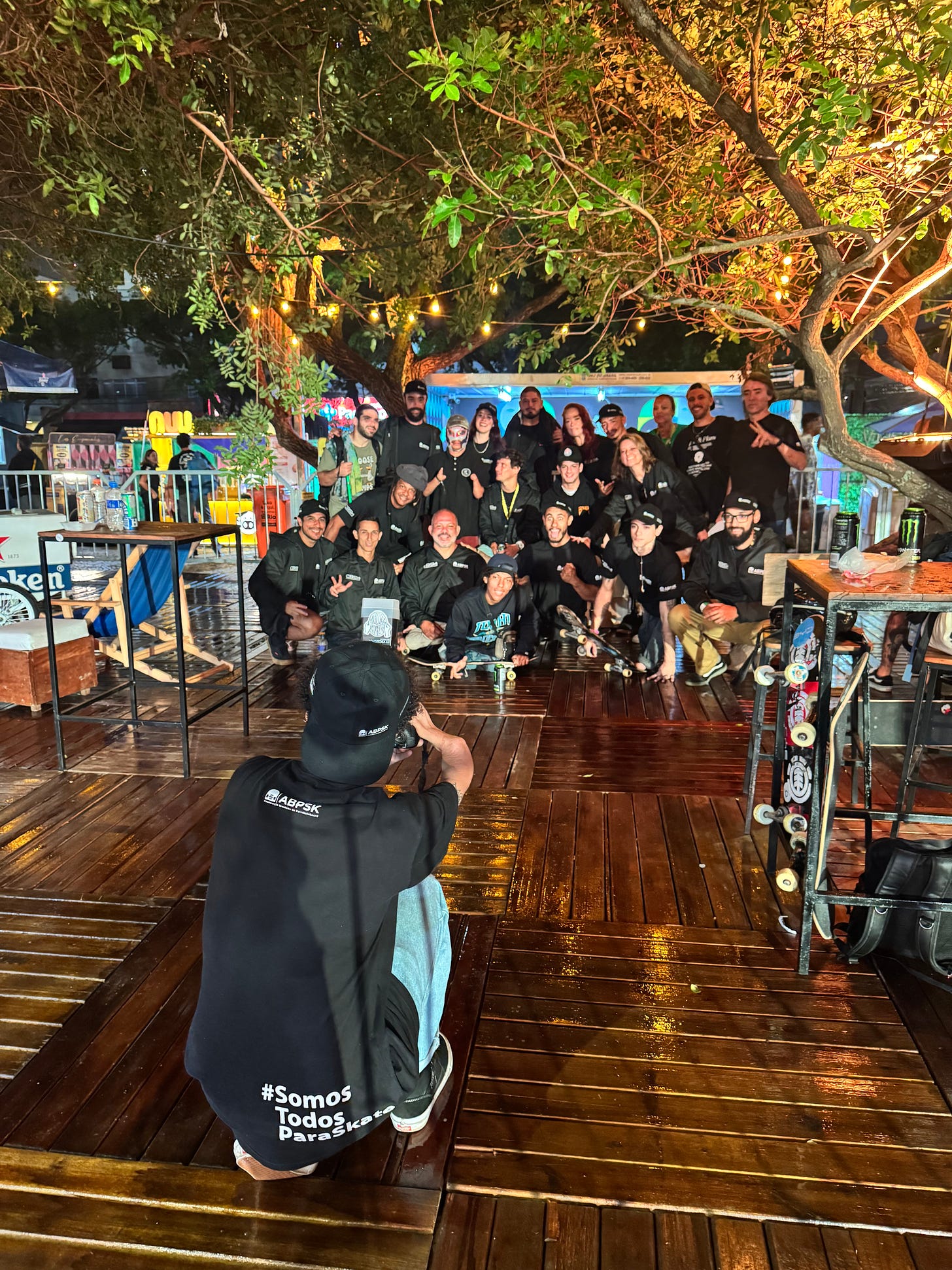 Brazil's para skateboarding team dressed in black all pose together for a photo at night at STU pro contest - some are blind some have limbs missing