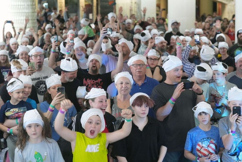 A large crowd begins to celebrate after being informed they have broken the Guinness World Record of number of people wearing underwear on their heads for at least one minute, at the City Museum in St. Louis on Thursday. The group of 355 broke the record which has stood at 270. Photo by Bill Greenblatt/UPI