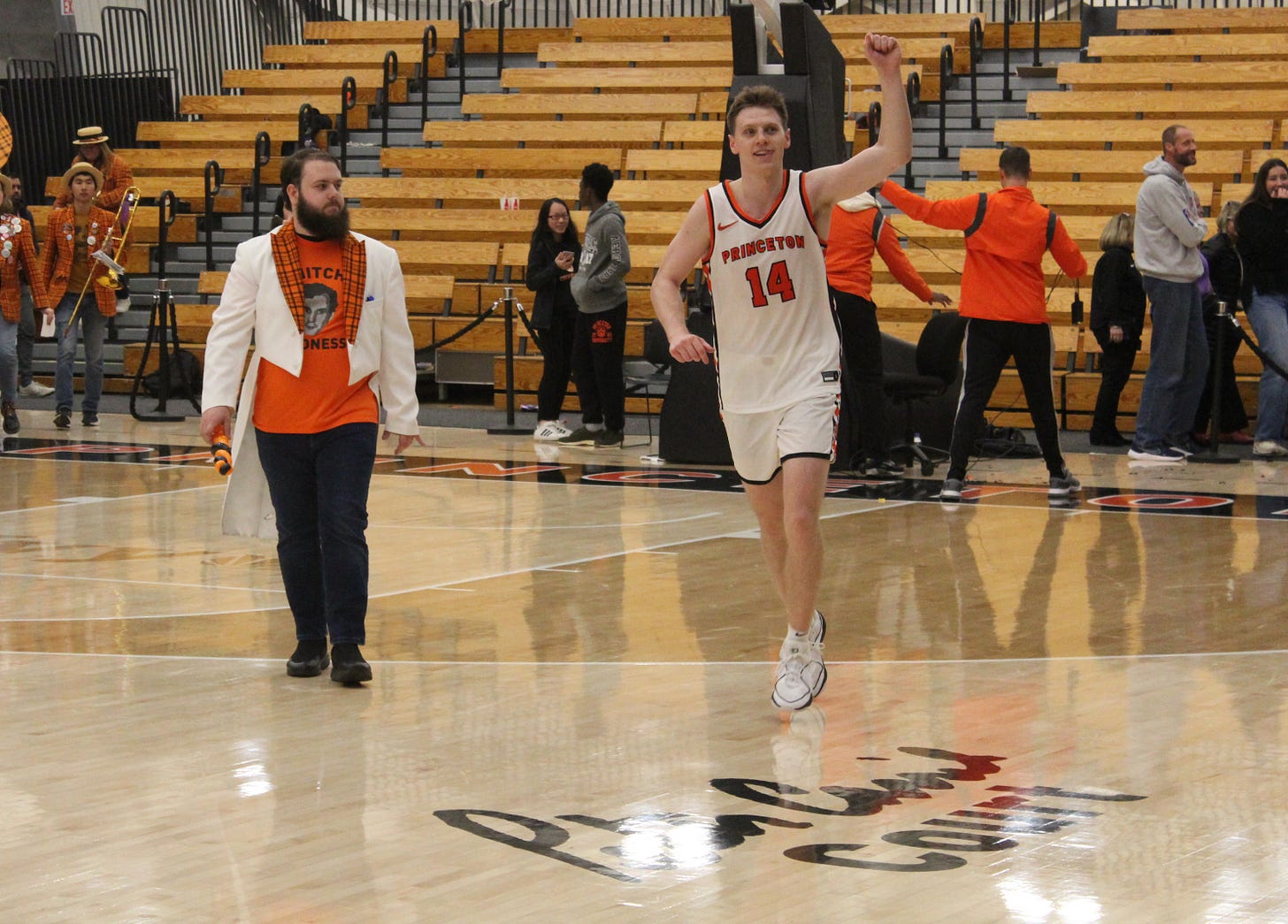Princeton’s Matt Allocco celebrates as he runs off the court after making a late 3-pointer to beat Furman on Dec. 2, 2023. (Photo by Adam Zielonka)
