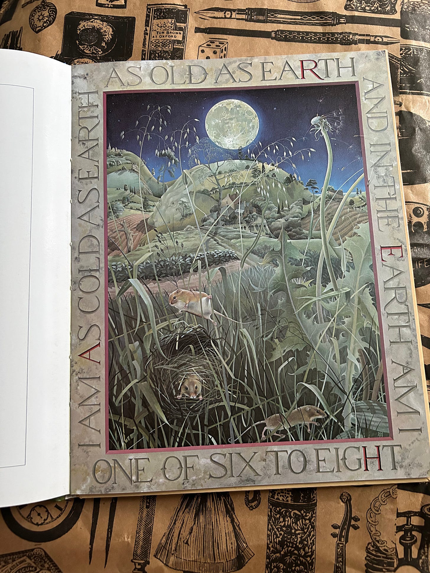 A page from Masquerade. The illustration is of a moonlight countryside scene. Round the edge there is wording reading “I am as cold as earth as old as earth and in the earth am I. One of six to eight”.