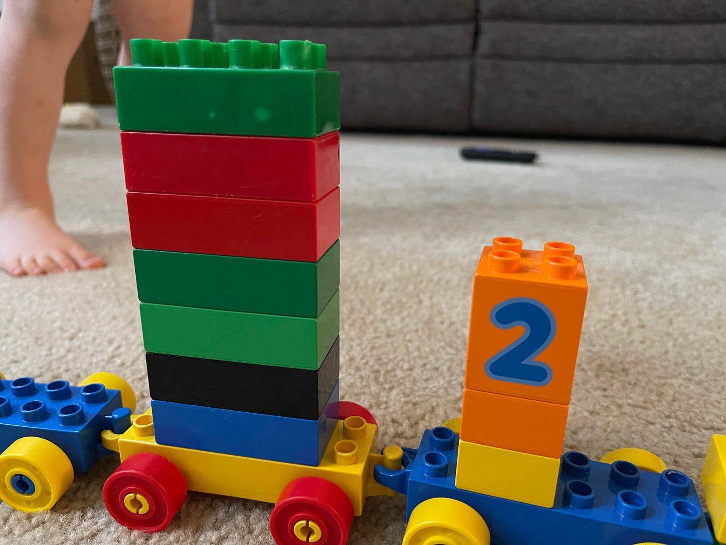 A smaller version of the “elevator train” featuring toddler feet