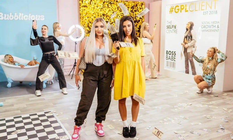 Fashion influencer Georgia Portogallo, left, and reporter Iman Amrani in Untold: Inside the Shein Machine. The two women look vibrant and sassy, and stand in a room where other influencers are taking photos. Photograph: Zandland.