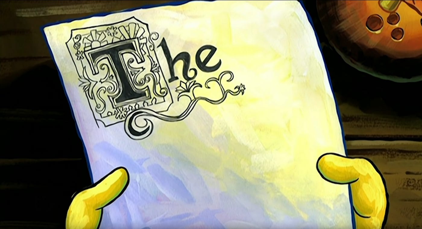 A close-up of Spongebob holding a piece of paper with a very ornate "The" on top. 