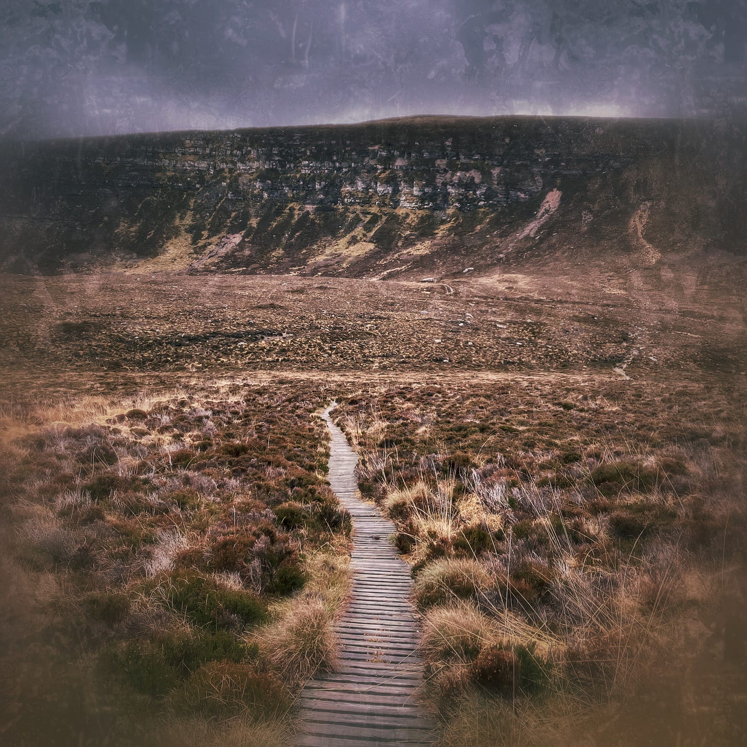 A antiqued looking photo of hills on the island of hoy and a wooden pathway leading over moorland. 