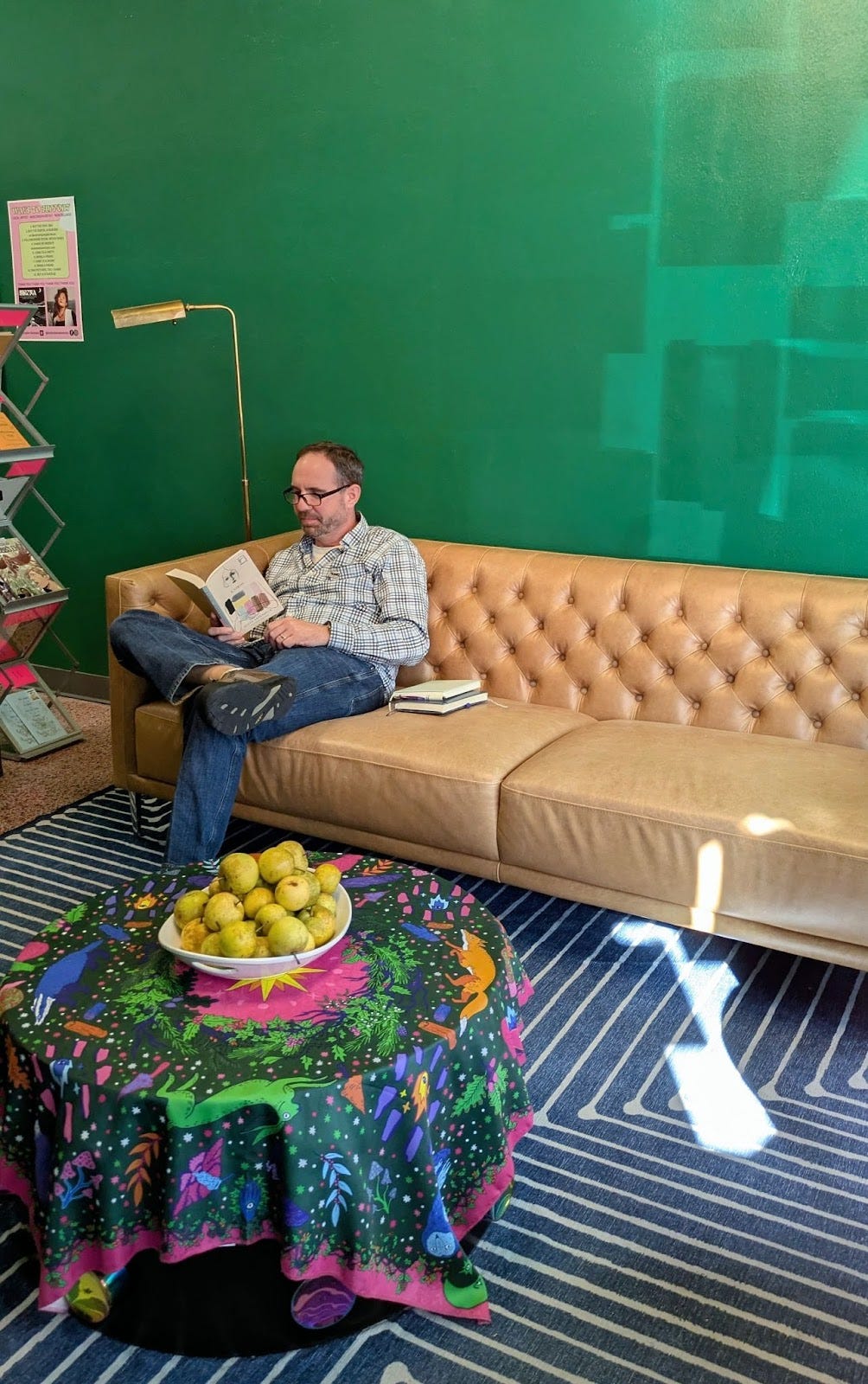 The author reading a book in a bookstore