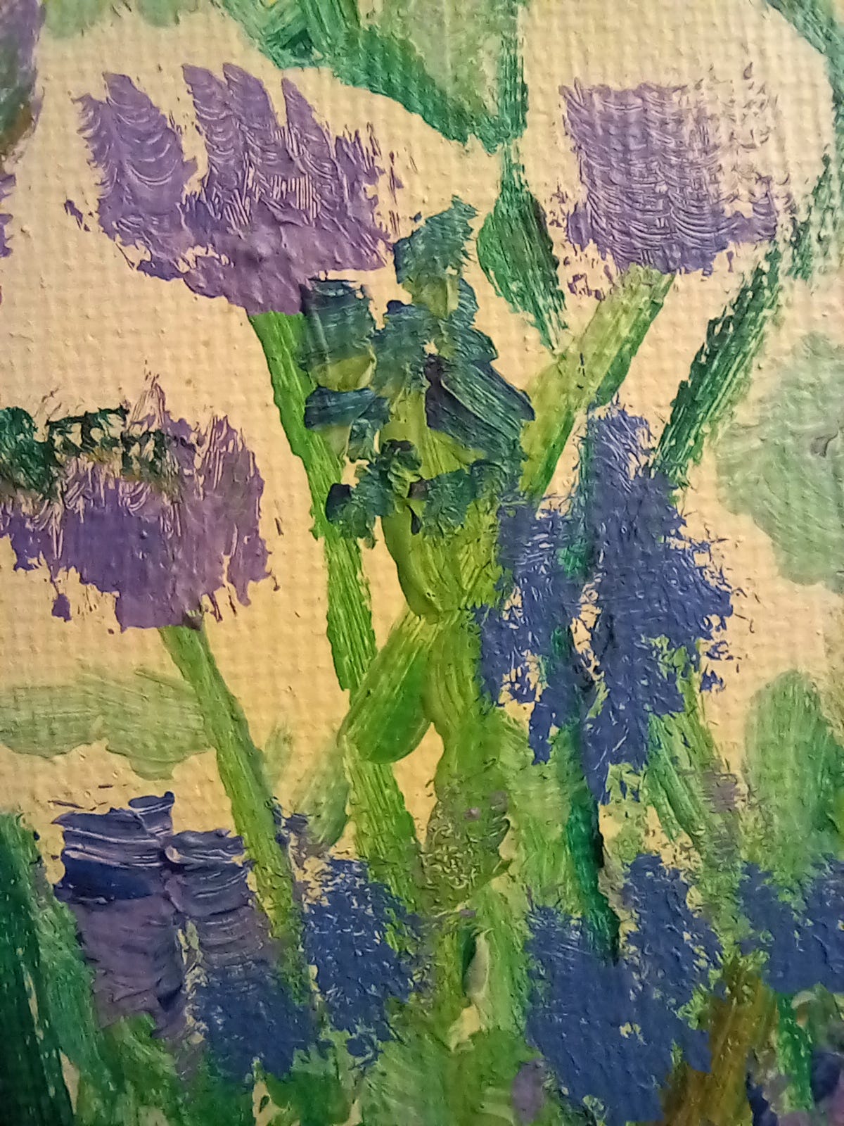 Close-up purple, green, and blue brushstrokes of a painting of flowers