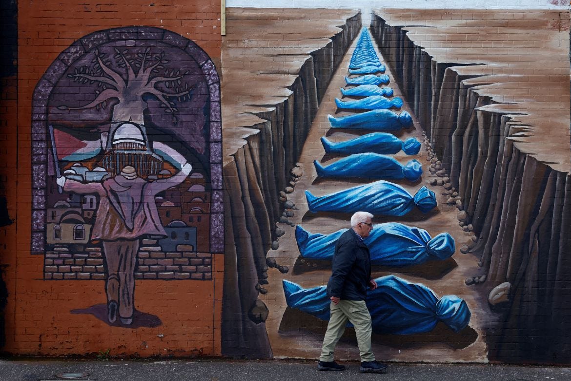 A man walks past pro-Palestinian murals on the International Wall in support of Gaza, amid the ongoing conflict between Israel and the Palestinian Islamist group Hamas, in Belfast, Northern Ireland, March 29 A man walks past pro-Palestinian murals on the International Wall in support of Gaza, amid the ongoing conflict between Israel and the Palestinian Islamist group Hamas, in Belfast, Northern Ireland, March 29