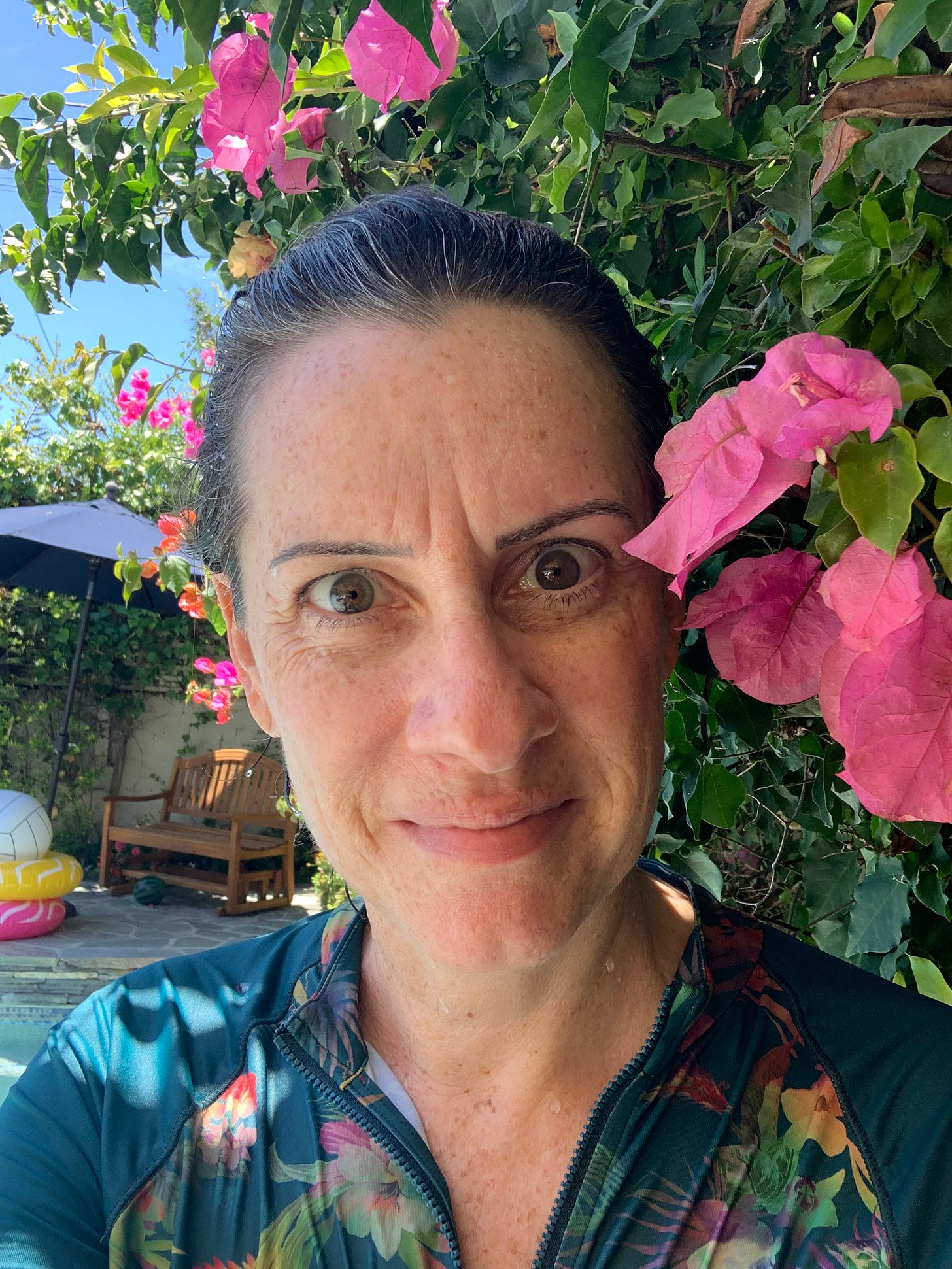 selfie photo of Elizabeth with wet hair from pool in a tropical setting