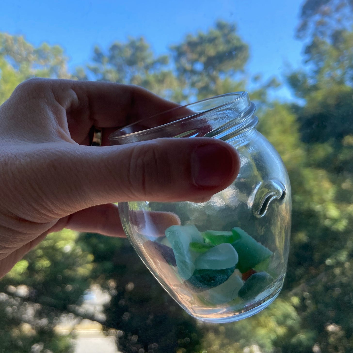 A small jar with a few pieces of sea glass