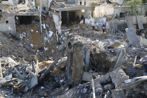 Palestinians look at the destruction by the Israeli bombardment of the Gaza Strip in Rafah, Monday, Dec. 4, 2023. (AP Photo/Hatem Ali)