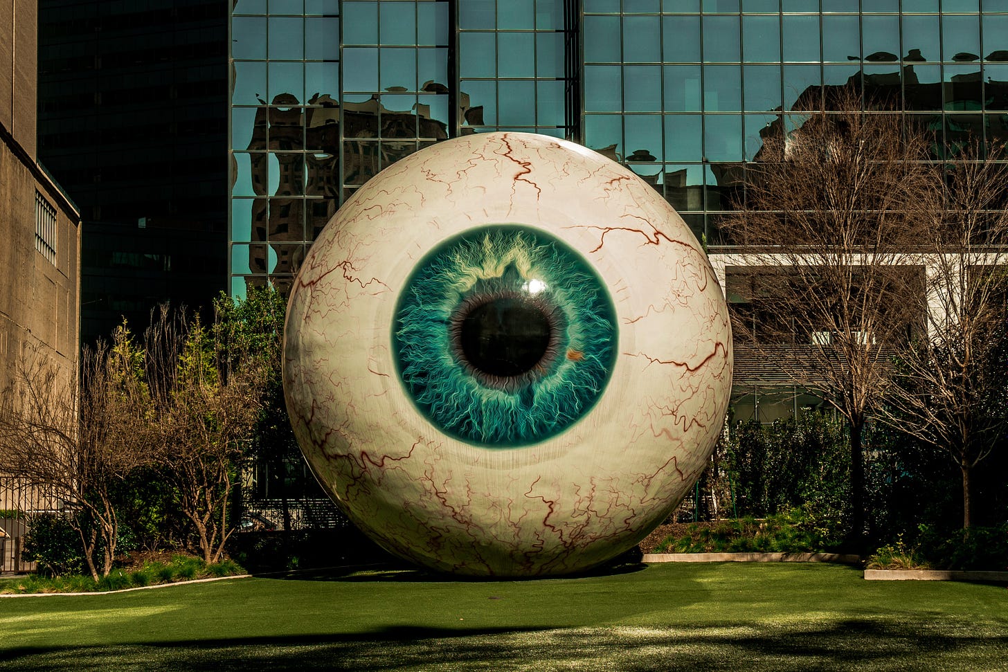 eyeball statue near building photo