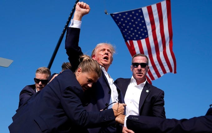 Bloodied face, fist raised in defiance: how this image may win Trump the US  presidency