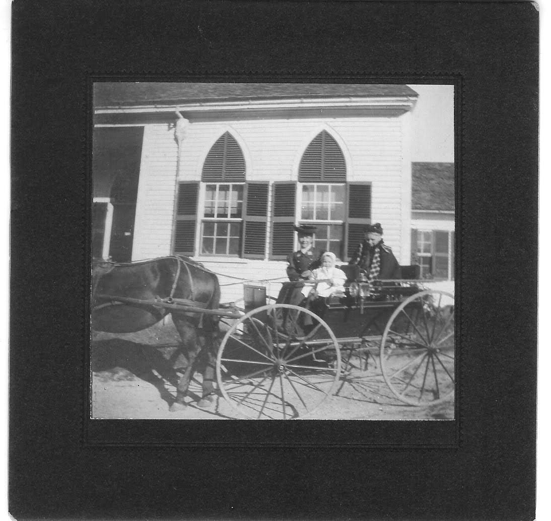 Two women and child in horse cart