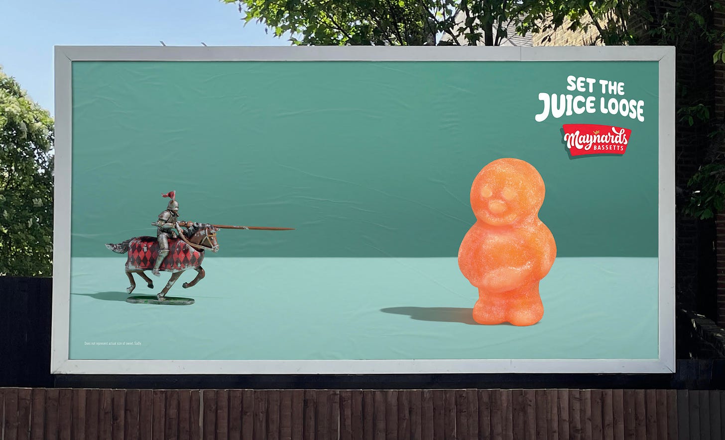 Poster showcasing a miniature model jouster on the left looking like it will pierce the skin of an orange jelly baby stood on the right side of the poster. Logo for Maynards Bassetts with endline saying set the juice loose in top right corner. 
The concept is to leave the viewer to imagine that when the jouster pierces the skin of the sweet it would set the juice loose much like the explosion of flavour that happens in your mouth when eating Jelly Babies. 