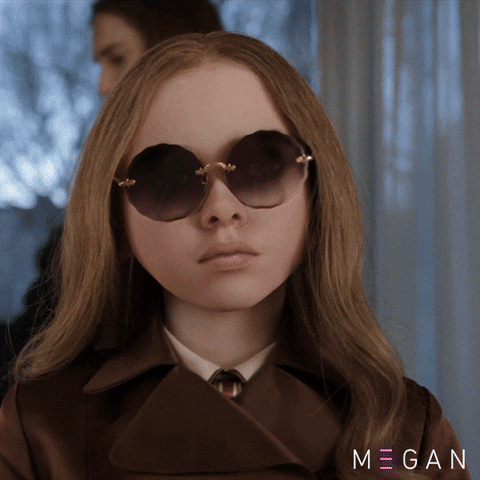 GIF: M3gan, the doll, takes off her sunglasses
