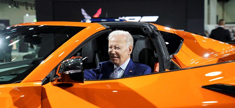 President Biden in a red car at a car show