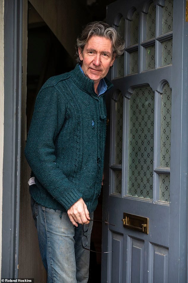Lloyd Evans poses for a photograph for MailOnline on his doorstep in East London on Thursday