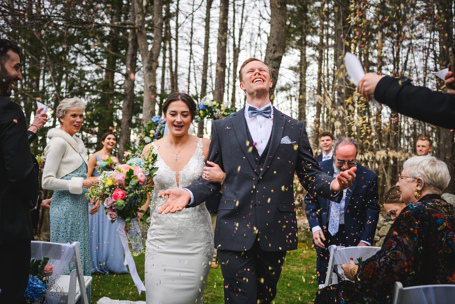 A bride and groom's recessional as guests throw dried flowers at them
