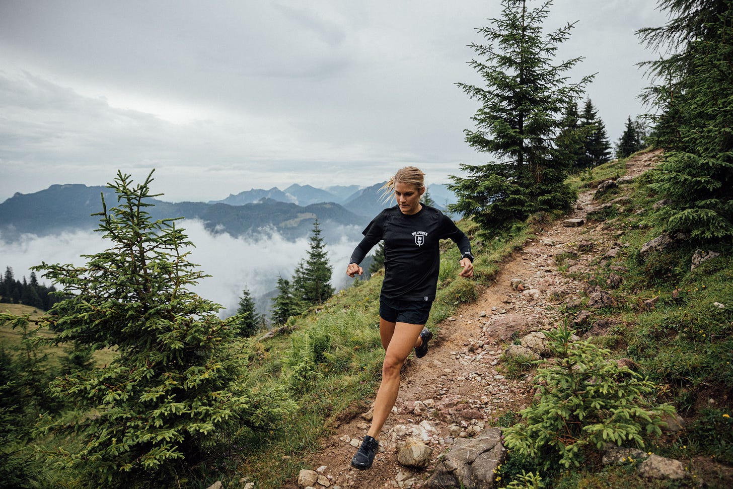 Female runner running a downhill trail