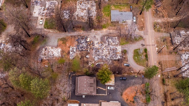 An aerial image shows the home of Sean and Dawn Herr, bottom center, in Paradise on Tuesday, March 19, 2019. The Herr home, built in 2010 to new fire-resistant building standards, survived the fire while nearby homes burned.