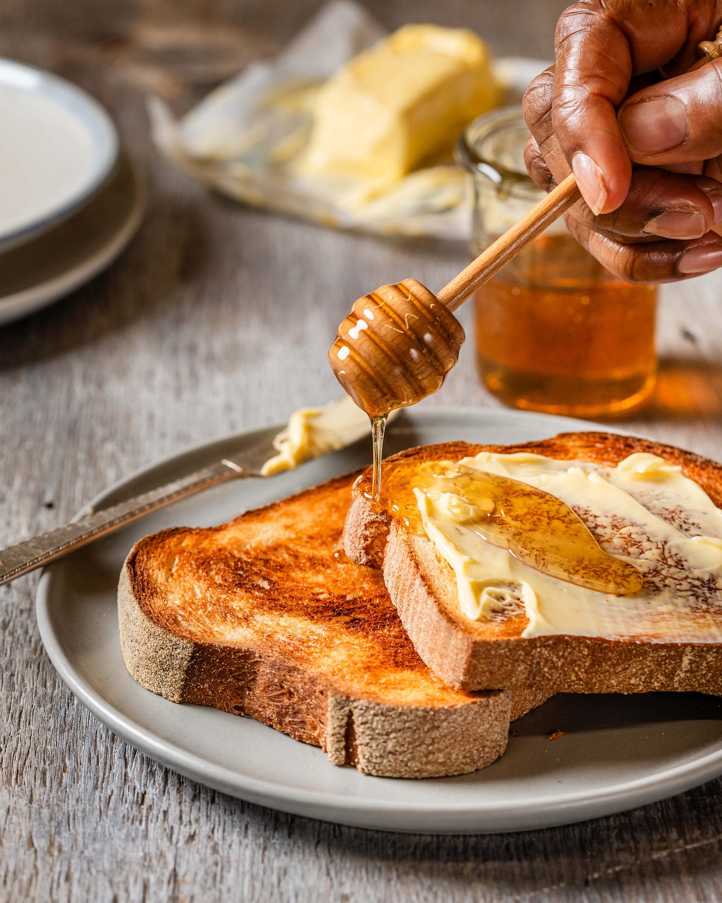 honey drizzling on slices of masa honey toasting bread.