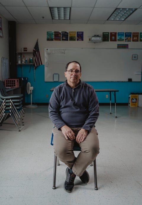 Man sits on chair in classroon
