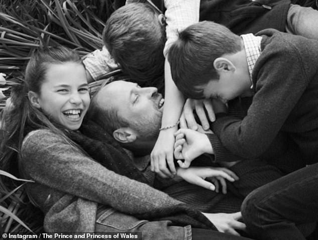In a second more candid black and white snap, the youngsters all tackle their father with hugs, laughing as they play around in some grass together