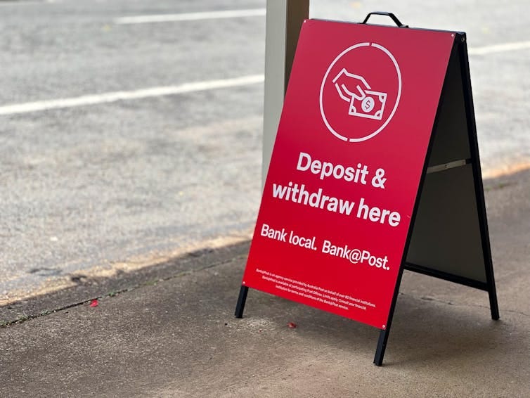 A-frame out the front of a post office, reading deposit and withdraw here