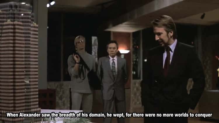 Still from Die Hard. Hans Gruber looks over the scale model of Nakatomi Plaza. Dialogue quoted on image: When Alexander saw the breadth of his domain, he wept, for there were no more worlds to conquer.