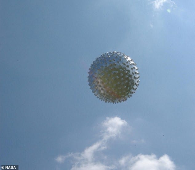 A former NASA astronaut has come forward to reveal that he personally witnessed 'two metallic spherical orbs' whizz by his plane while flying above Texas. Above, an example of a 'metallic sphere' weather balloon included in a 2023 report by NASA's UFO advisory panel