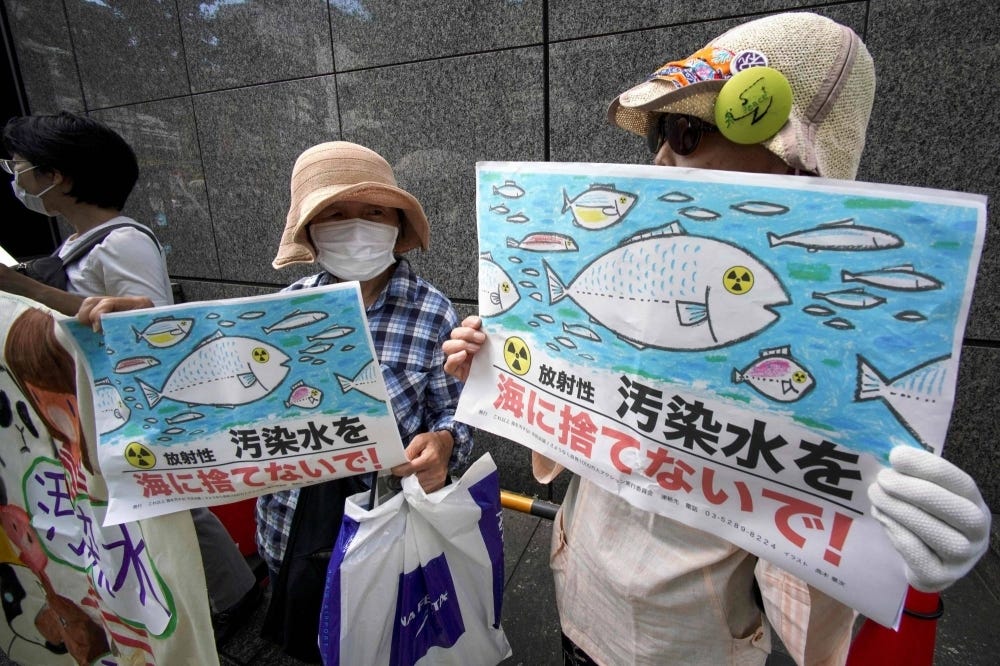 Protesters opposed to the water release rally outside Tepco's headquarters in Tokyo on Thursday. 