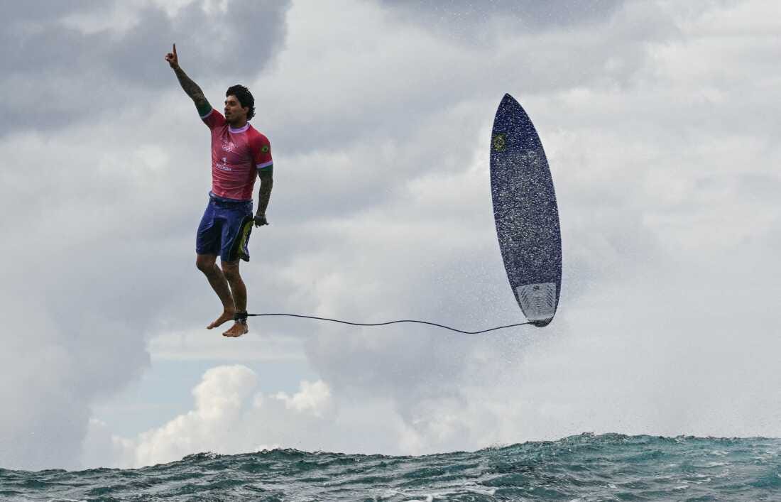 Brazil's Gabriel Medina reacts after getting a large wave in the 5th heat of the men's surfing round 3 on Monday.