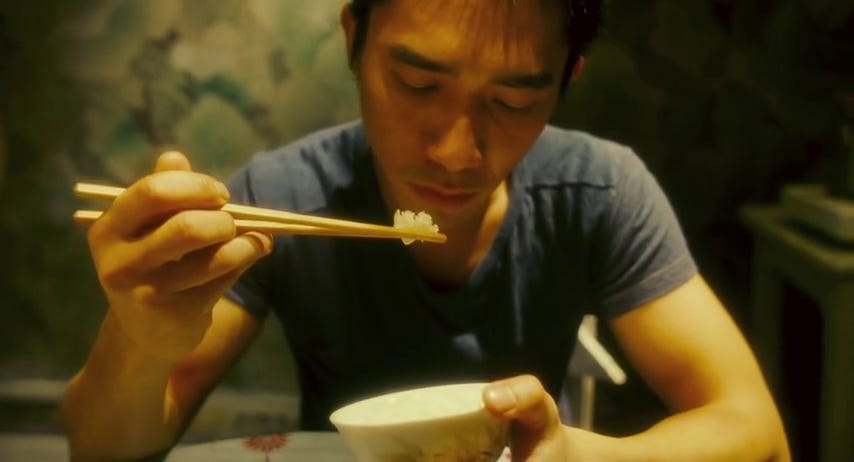 Tony Leung eats alone in "Happy Together" (1997)