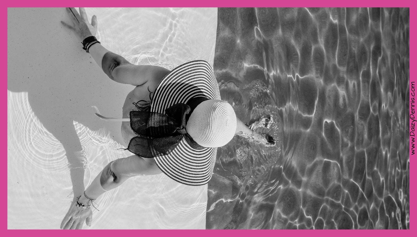 woman in sunhat paddling in pool luxury vibes