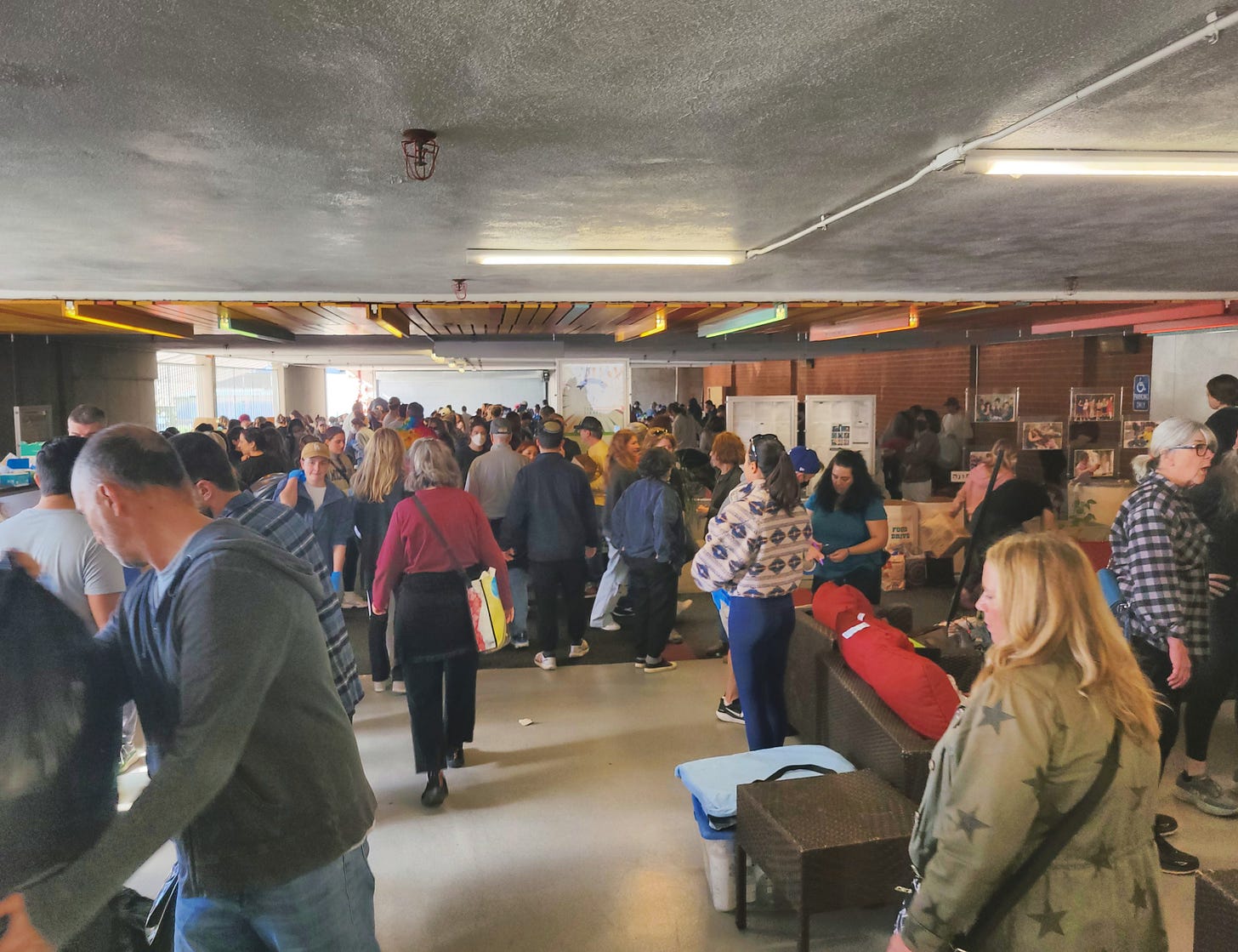 A picture of the donation center at the Temple Israel of Hollywood. There are dozens of people scurrying about, sorting, donating.