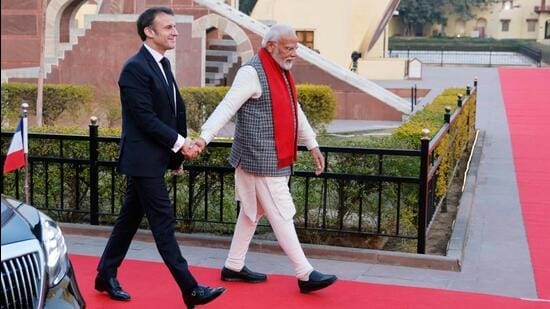 Prime Minister Narendra Modi (R) and France's President Emmanuel Macron shake hands as they walk during a visit to the Janta Mantar observatory in Jaipur on January 25 (AFP)