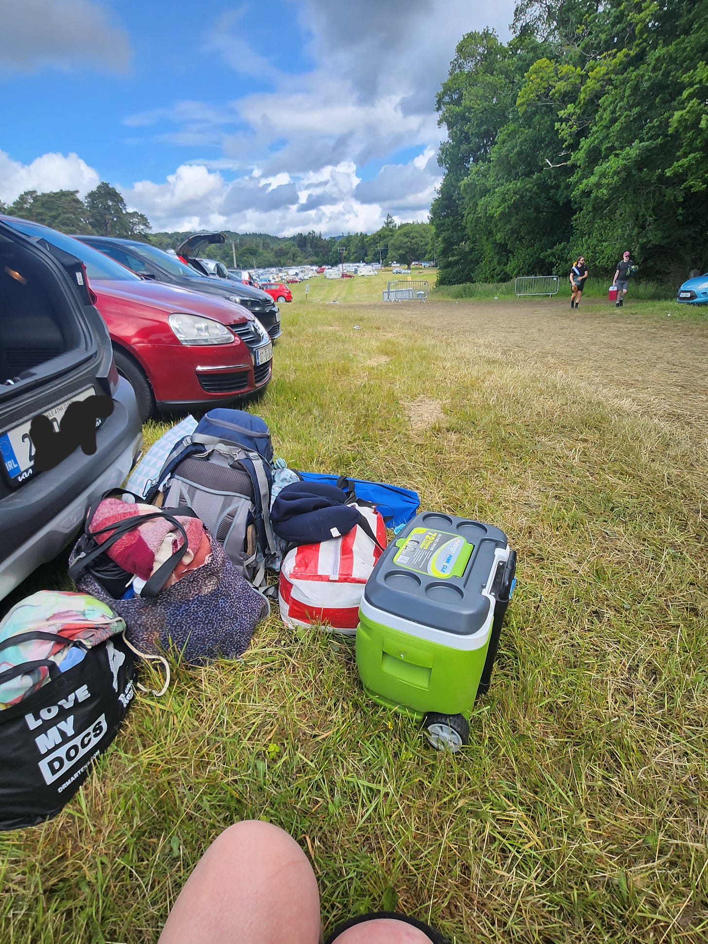 From my viewpoint as a wheelchair user, I have bags and tents and water coolers piled beside the open boot of a car, as blue skies start to push the grey clouds away on the very last day of Beyond the Pale. 
