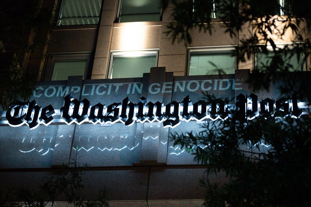 A projection declares the Washington Post "complicit in genocide" during a march for Gaza on a worldwide day of action for Palestine, October 12, 2023. Protesters accuse the Post and other Western news outlets of bias in their coverage of the Hamas attacks and their aftermath. Demonstrations are taking place worldwide in support of the innocent Palestinian civilians who had no role in the attacks, but are harmed by the response. (Photo by Allison Bailey/NurPhoto via AP) A projection declares the Washington Post "complicit in genocide" during a march for Gaza on a worldwide day of action for Palestine, October 12, 2023. Protesters accuse the Post and other Western news outlets of bias in their coverage of the Hamas attacks and their aftermath. Demonstrations are taking place worldwide in support of the innocent Palestinian civilians who had no role in the attacks, but are harmed by the response. (Photo by Allison Bailey/NurPhoto via AP)