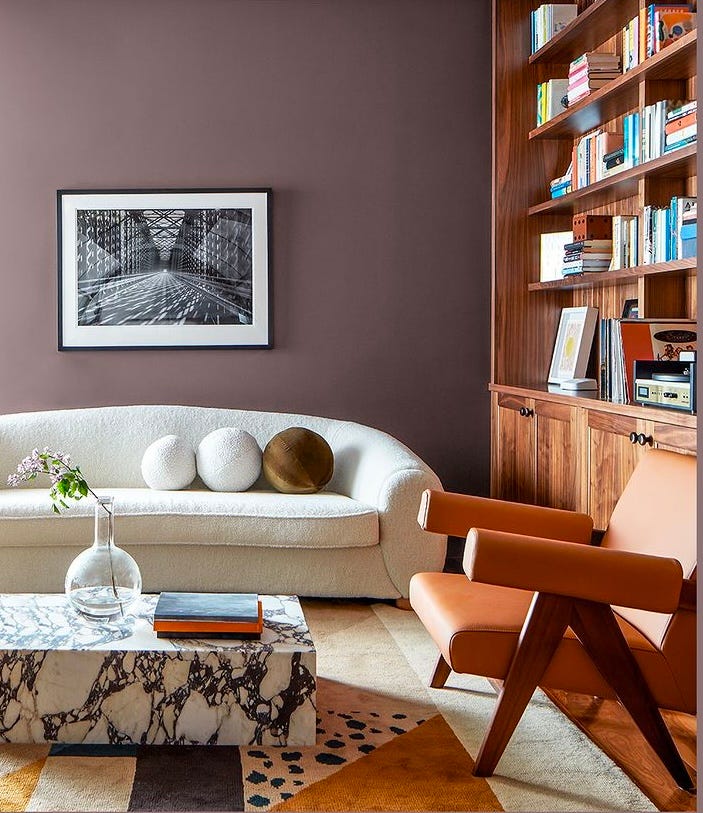 living room with cinnamon slate painted wall alongside white sofa and warm wooden furniture