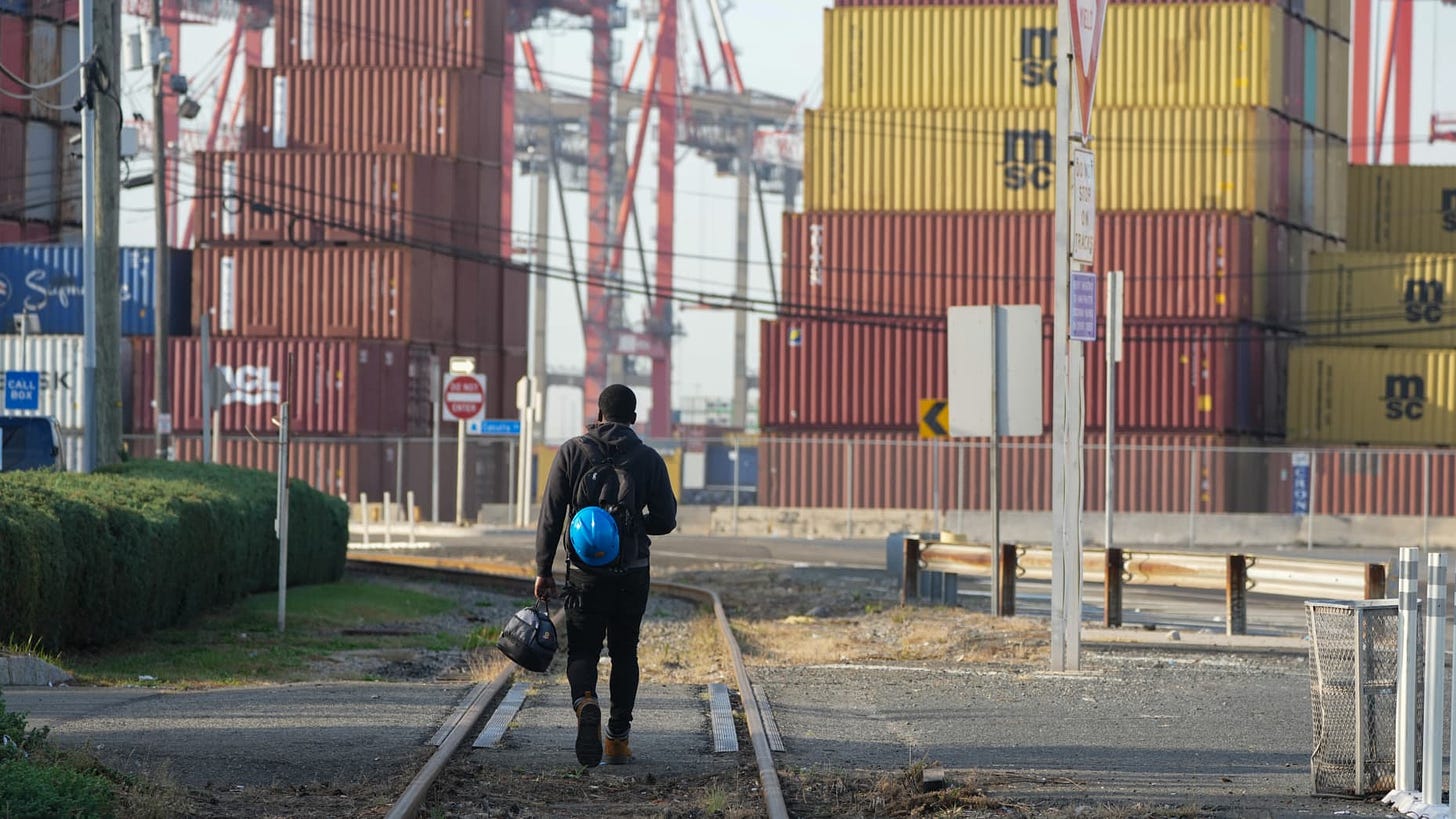 A man walks along the railroad tracks at Port Newark in New Jersey, on October 4, 2024. US dockworkers will return to work after a three-day strike at East and Gulf Coast ports after the union and port operators reached a tentative deal on pay and extended the current contract to January 15, both sides said Thursday. (Photo by Bryan R. SMITH / AFP) (Photo by BRYAN R. SMITH/AFP via Getty Images)