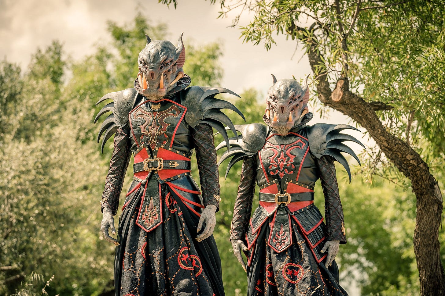 This image shows two extraterrestrial Thijarians (played by Nathalie Curzner and Barbara Fadden), dressed in their impressively designed costumes, standing in a copse of Punjabi trees during the events of "Demons of the Punjab" (Doctor Who Series 11's sixth episode). This image shows two extraterrestrial Thijarians (played by Nathalie Curzner and Barbara Fadden), dressed in their impressively designed costumes, standing in a copse of Punjabi trees during the events of "Demons of the Punjab" (Doctor Who Series 11's sixth episode).
