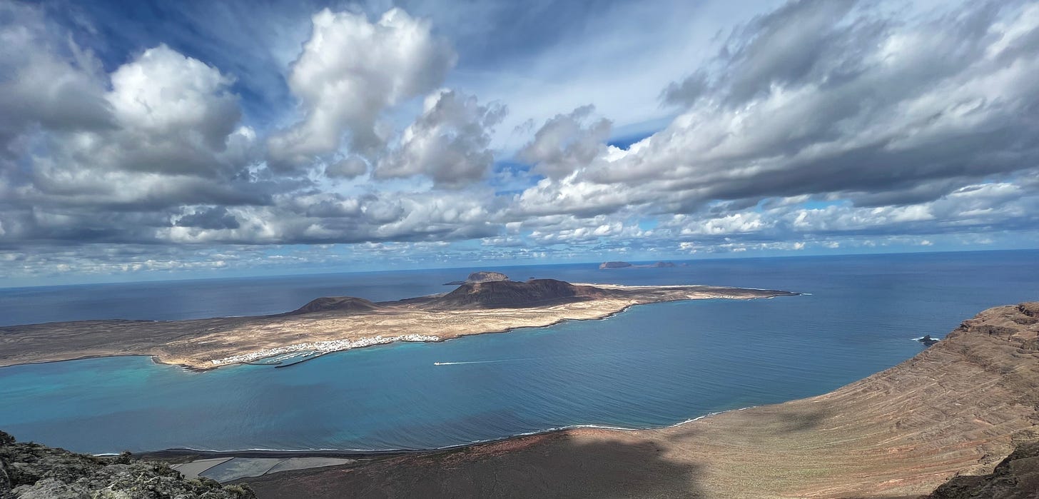 Photo of cloudy sky over a volcanic island