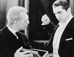  Van Helsing (Edward Van Sloan) showing Dracula (Bela Lugosi) a mirror, in "Dracula." (Public Domain)