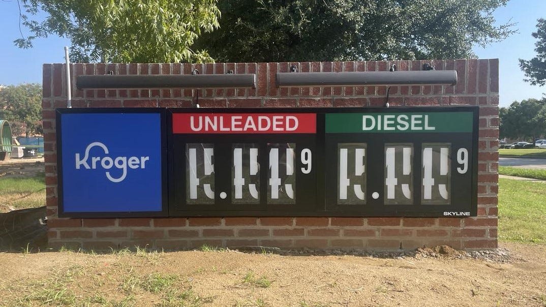 A monument sign bearing the Kroger logo and prices for unleaded and diesel gasoline