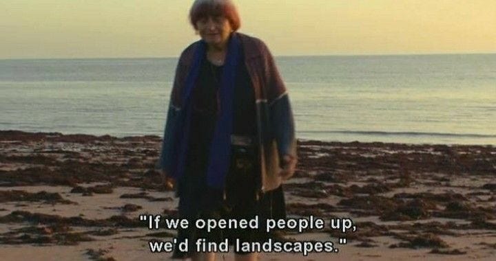 This may contain: a woman standing on top of a sandy beach next to the ocean with a quote