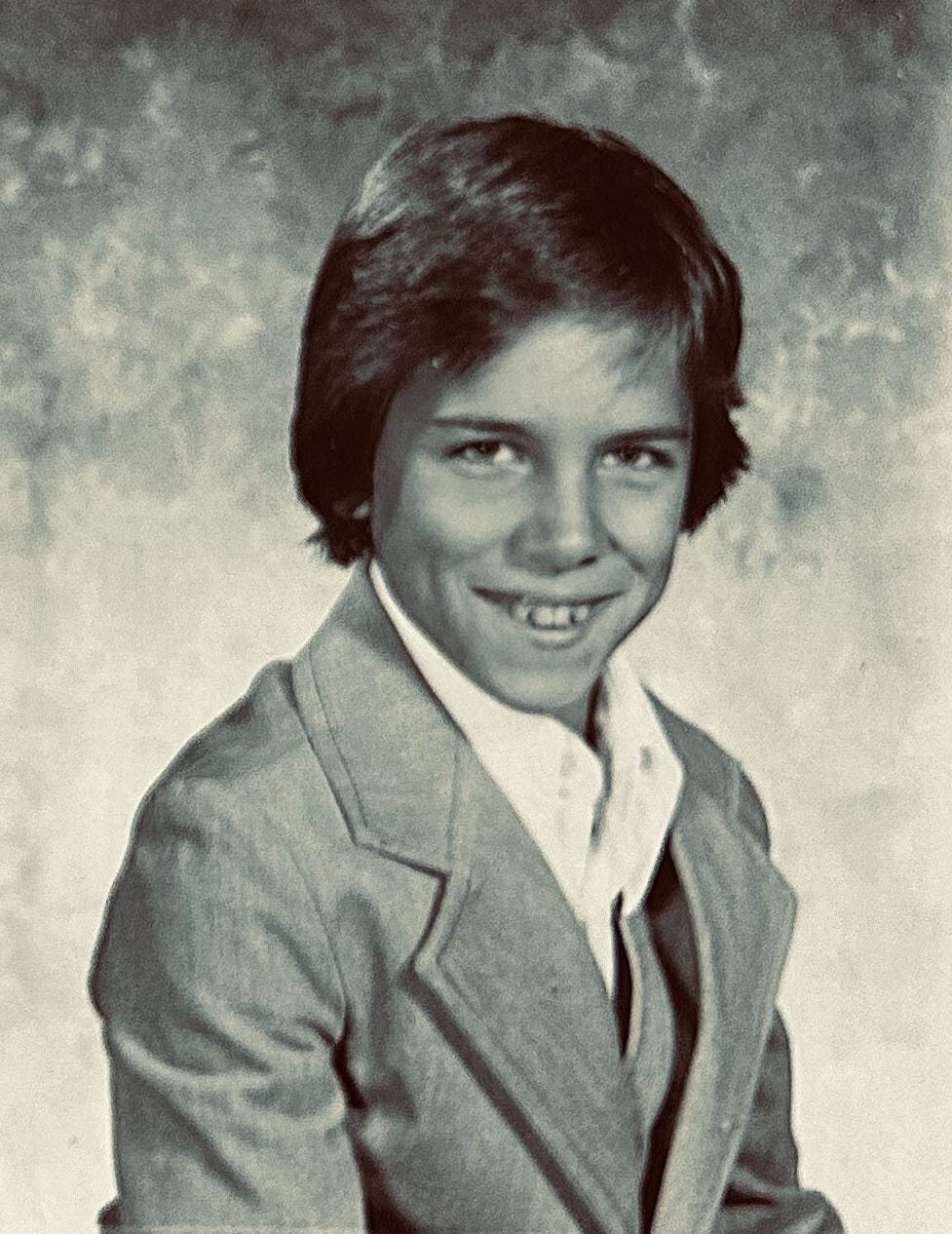 Faux Jean wearing a 3-piece suit for his 5th grade picture