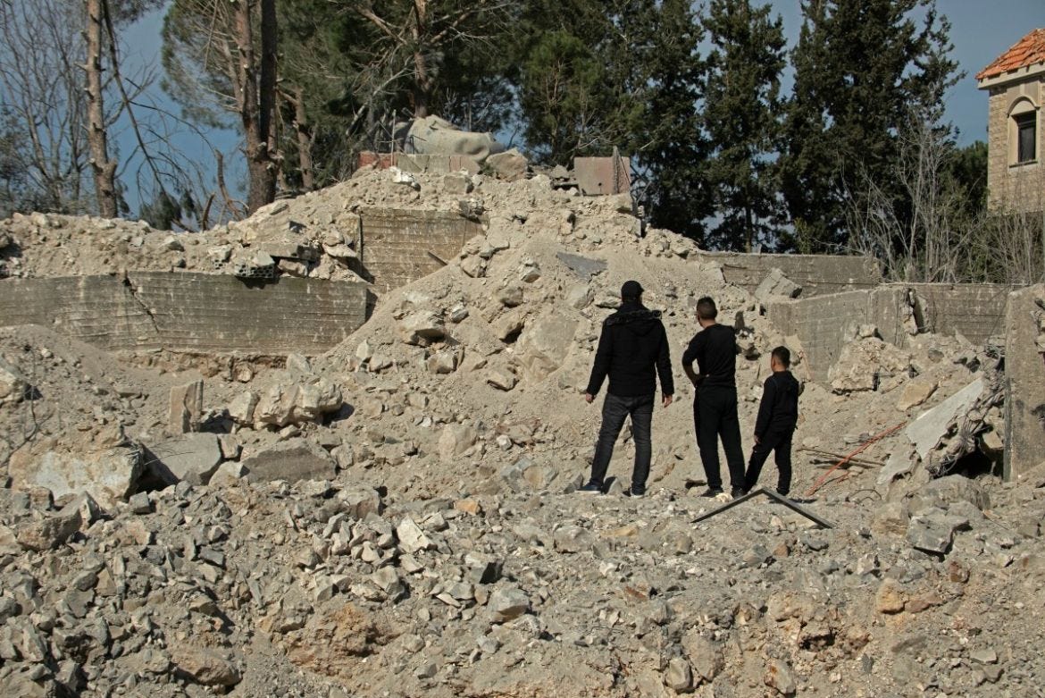 Residents and rescuers check the destruction after an overnight Israeli bombardment in the southern Lebanese village of Kafra