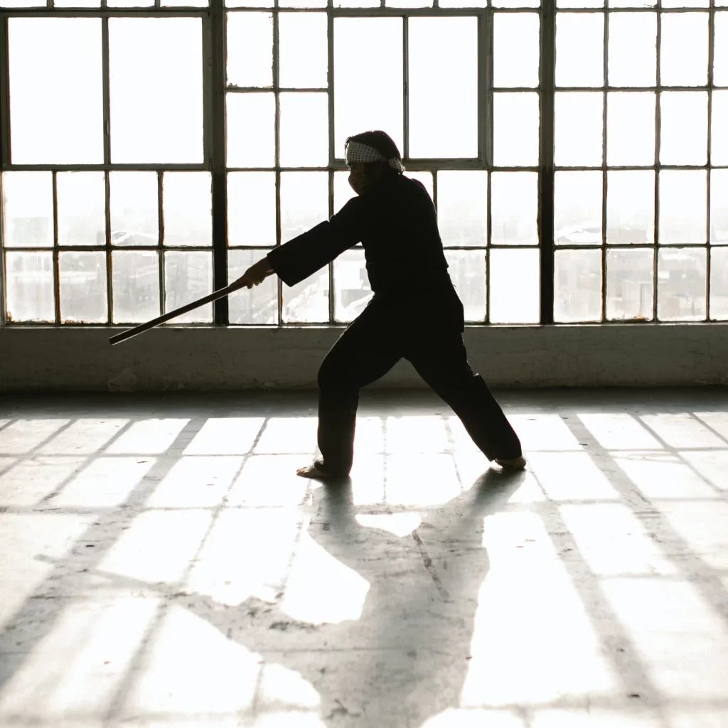 Black and white picture of a martial artist in silhouette practicing with a wooden sword