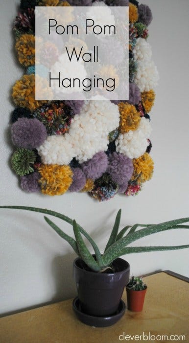 Visit cleverbloom.com for easy to follow instructions on how to make this DIY Pom Pom Wall Hanging. It's super groovy with a 70's vibe that will make a great conversation piece!