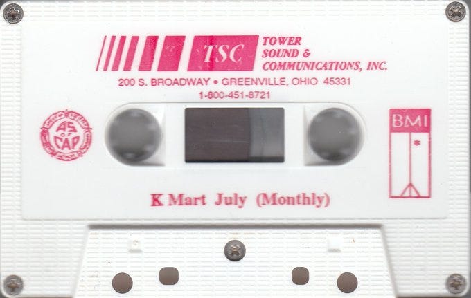 White cassette tape with pink lettering. Tower Sound & Communications, Inc. K Mart July (Monthly)